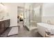 Modern bathroom featuring a separate shower, tub, and dual vanity sinks at 1221 Azalea Garden Cir, Raleigh, NC 27603