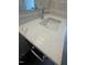 Close-up of a bathroom vanity featuring a white quartz countertop and a modern chrome faucet at 1221 Azalea Garden Cir, Raleigh, NC 27603