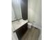 Modern half bath boasts a sleek vanity, contemporary fixtures, and stylish black accent wall at 1221 Azalea Garden Cir, Raleigh, NC 27603