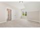 An empty room featuring plush carpet and a window that brings in natural light at 1221 Azalea Garden Cir, Raleigh, NC 27603