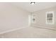 Bright bedroom boasts neutral walls, plush carpet, and natural light from the double-hung windows at 1221 Azalea Garden Cir, Raleigh, NC 27603