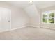 An empty room featuring plush carpet and a large window for plenty of light at 1221 Azalea Garden Cir, Raleigh, NC 27603