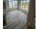 Bright dining area with large windows and stylish wood-look flooring at 1221 Azalea Garden Cir, Raleigh, NC 27603