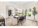 Bright dining room with large windows, modern lighting, and a view into the office at 1221 Azalea Garden Cir, Raleigh, NC 27603