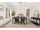 Inviting dining room featuring neutral tones, a modern light fixture, and a view of the yard at 1221 Azalea Garden Cir, Raleigh, NC 27603