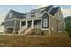 Charming two-story home featuring a welcoming front porch with white columns and a well-maintained lawn at 1221 Azalea Garden Cir, Raleigh, NC 27603