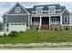 Charming two-story home with a covered front porch, well-manicured lawn, and a two-car garage at 1221 Azalea Garden Cir, Raleigh, NC 27603