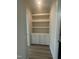 Well-lit hallway features a built-in cabinet and open shelving for functional storage at 1221 Azalea Garden Cir, Raleigh, NC 27603