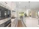 Bright and airy kitchen features white cabinets, stainless steel appliances, and eat-in breakfast area at 1221 Azalea Garden Cir, Raleigh, NC 27603