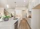 Modern kitchen featuring stainless steel appliances, white cabinets, and a large center island at 1221 Azalea Garden Cir, Raleigh, NC 27603