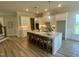 Spacious kitchen with a large center island, white cabinets, and hardwood floors at 1221 Azalea Garden Cir, Raleigh, NC 27603