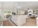 Open-concept kitchen flows into the living room, complete with island and stainless steel appliances at 1221 Azalea Garden Cir, Raleigh, NC 27603