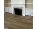 Close up on a living room fireplace with wood floors and a mantle at 1221 Azalea Garden Cir, Raleigh, NC 27603