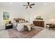 Beautiful main bedroom with area rug, bench, furniture, and ceiling fan at 1221 Azalea Garden Cir, Raleigh, NC 27603