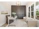 Stylish home office with large window, accent wall, and comfortable seating area at 1221 Azalea Garden Cir, Raleigh, NC 27603