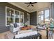 Screened porch offers a comfortable seating area with stylish decor and natural light at 1221 Azalea Garden Cir, Raleigh, NC 27603