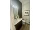Stylish powder room with modern fixtures, contrasting walls, and elegant decor at 1221 Azalea Garden Cir, Raleigh, NC 27603