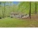 Backyard of property with a covered seating area and lush green grass at 1332 Stallings Rd, Chapel Hill, NC 27516