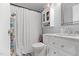 Clean bathroom features a vanity with storage, commode and shower with a white shower curtain at 1332 Stallings Rd, Chapel Hill, NC 27516