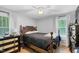 Bedroom features wood floors, ceiling fan, and natural light from the two windows at 1332 Stallings Rd, Chapel Hill, NC 27516