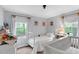 Bedroom with hardwood floors, two windows, light grey walls, and white metal bed frame at 1332 Stallings Rd, Chapel Hill, NC 27516
