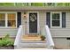 Charming home featuring a quaint entryway with decorative wreath and welcome sign at 1332 Stallings Rd, Chapel Hill, NC 27516