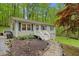 Charming home featuring light gray siding, a welcoming front porch, and landscaped front yard with mature trees at 1332 Stallings Rd, Chapel Hill, NC 27516