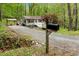 Charming home featuring light gray siding, a welcoming front porch, and a gravel driveway with a mailbox at 1332 Stallings Rd, Chapel Hill, NC 27516
