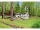 Charming single-Gathering home with inviting entrance, nestled amongst mature trees and lush landscaping at 1332 Stallings Rd, Chapel Hill, NC 27516