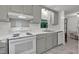 Bright kitchen features white appliances, gray cabinets, and updated counters at 1332 Stallings Rd, Chapel Hill, NC 27516
