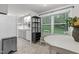 Bright kitchen with a refrigerator, sink, table, chairs, and a view of the green backyard through a large window at 1332 Stallings Rd, Chapel Hill, NC 27516