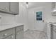 A view of the kitchen that shows the pantry, appliances, and a door to the outside at 1332 Stallings Rd, Chapel Hill, NC 27516