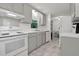 A view of the kitchen features essential appliances and fixtures, with a small view to the dining room at 1332 Stallings Rd, Chapel Hill, NC 27516