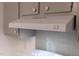 White range hood with light and fan controls mounted above a light grey backsplash and cabinetry at 1332 Stallings Rd, Chapel Hill, NC 27516