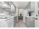 A view of the kitchen features essential appliances and fixtures, with a small view to the dining room at 1332 Stallings Rd, Chapel Hill, NC 27516