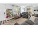 Cozy living room with windows, a comfortable sofa, and a bookshelf filled with books and toys at 1332 Stallings Rd, Chapel Hill, NC 27516