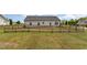 Backyard with a well-maintained lawn, a wooden fence, and the rear exterior of the house at 158 Blande Dr, Kenly, NC 27542