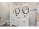 Well-lit bathroom featuring double sinks, modern fixtures, and a shower/tub combination with a colorful curtain at 158 Blande Dr, Kenly, NC 27542