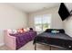 Cozy bedroom with two beds, a mounted TV, and a window allowing natural light to brighten the room at 158 Blande Dr, Kenly, NC 27542