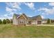 Single-story home with beige siding and a stone facade, a well maintained lawn, and an attached garage at 158 Blande Dr, Kenly, NC 27542
