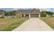 Single-story home with stone facade, a two-car garage, and green lawn at 158 Blande Dr, Kenly, NC 27542