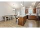 Kitchen with island, granite countertops, wood cabinets and open dining area at 158 Blande Dr, Kenly, NC 27542