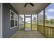 Screened in back porch featuring a ceiling fan, wood floors, and an exterior view of the backyard at 163 S Harper Faith Way, Benson, NC 27504