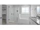 Modern bathroom boasting a glass-enclosed shower, soaking tub, and granite countertops at 163 S Harper Faith Way, Benson, NC 27504