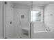 Modern bathroom featuring a glass-enclosed shower, a soaking tub, and white subway tile at 163 S Harper Faith Way, Benson, NC 27504