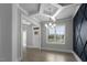 Elegant dining room features an accent wall, modern chandelier, and large window with natural light at 163 S Harper Faith Way, Benson, NC 27504