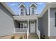 Charming front porch with white railings and pillars, leading to the main entrance of the home at 163 S Harper Faith Way, Benson, NC 27504