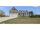 Charming two-story home with blue siding, stone accents, and an attached two-car garage at 163 S Harper Faith Way, Benson, NC 27504