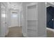 Bright entryway featuring light wood floors, a built-in shelving unit, and a glimpse into other rooms at 163 S Harper Faith Way, Benson, NC 27504