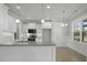 A modern kitchen featuring granite counters, pendant lighting, and sleek, white cabinetry at 163 S Harper Faith Way, Benson, NC 27504
